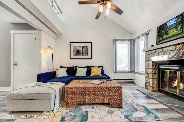 living room featuring a fireplace, wood-type flooring, ceiling fan, baseboard heating, and a textured ceiling