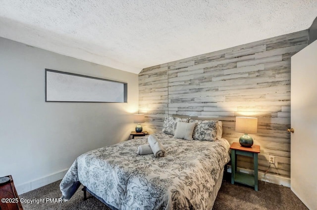 carpeted bedroom featuring wooden walls and a textured ceiling