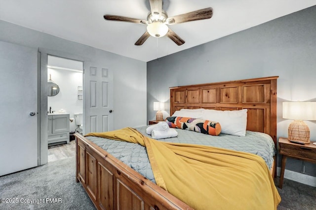 bedroom featuring ensuite bathroom, light colored carpet, and ceiling fan