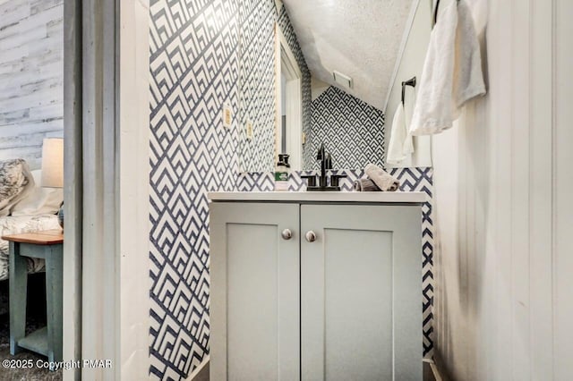 bathroom with vanity and a textured ceiling