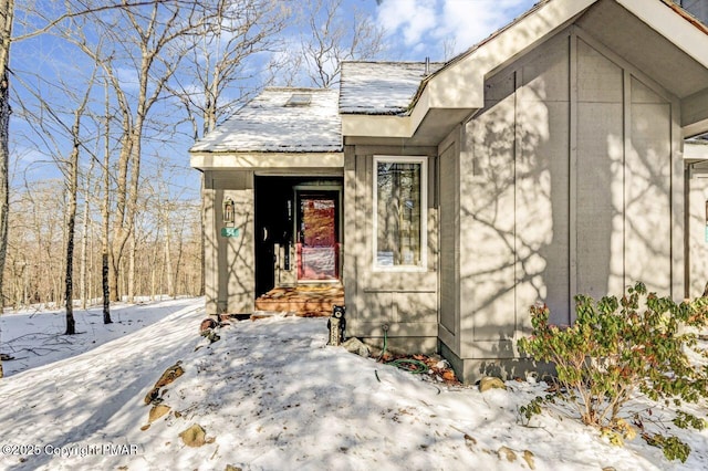 view of snow covered property entrance