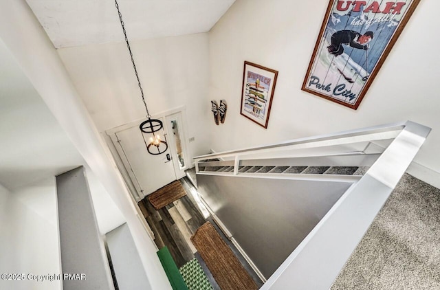 stairway featuring wood-type flooring