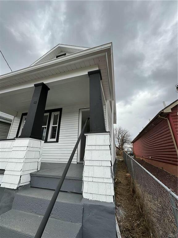 exterior space with a porch and fence