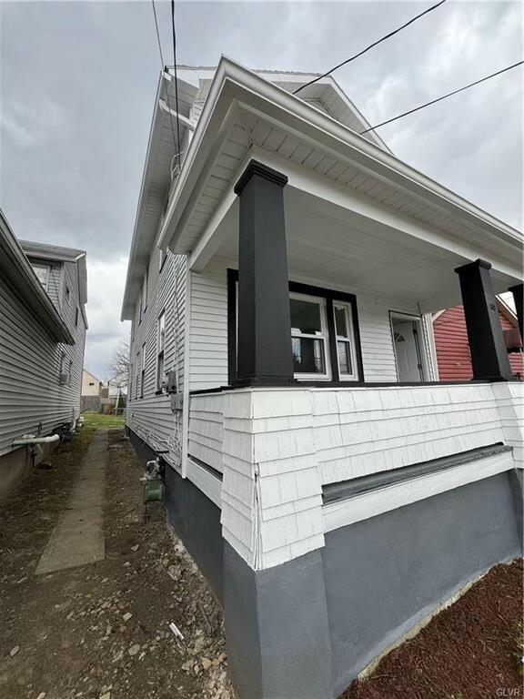 view of side of home featuring a porch