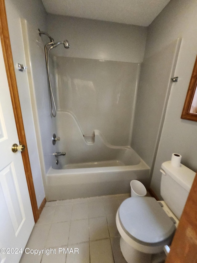 full bath featuring tile patterned floors, toilet, and tub / shower combination