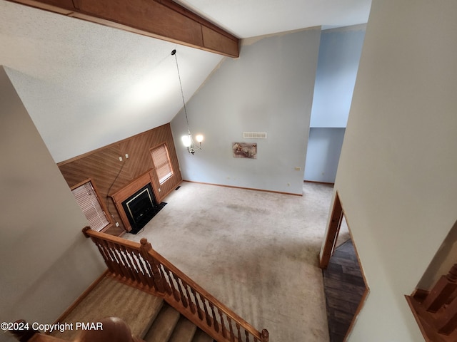 stairs with beamed ceiling, visible vents, a fireplace, carpet flooring, and baseboards