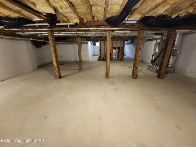 unfinished basement featuring heating unit