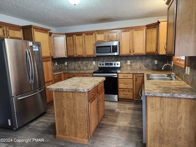 kitchen with dark wood-style flooring, a sink, decorative backsplash, appliances with stainless steel finishes, and brown cabinets