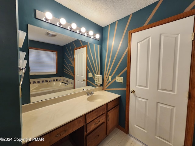 full bath featuring tile patterned floors, a garden tub, a textured ceiling, wallpapered walls, and vanity