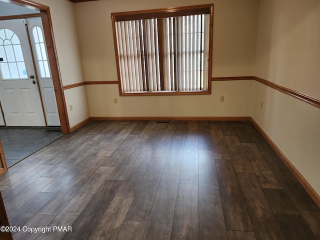 interior space featuring visible vents, baseboards, and dark wood-style flooring