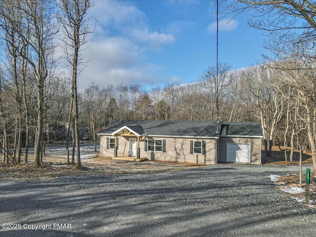 view of front of house with aphalt driveway and an attached garage