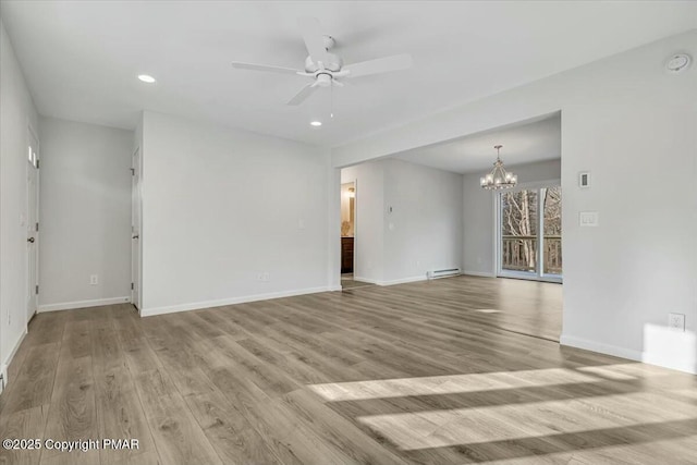 unfurnished room featuring ceiling fan with notable chandelier, baseboards, baseboard heating, and wood finished floors