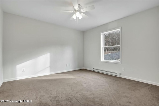 carpeted spare room with a baseboard heating unit, ceiling fan, and baseboards