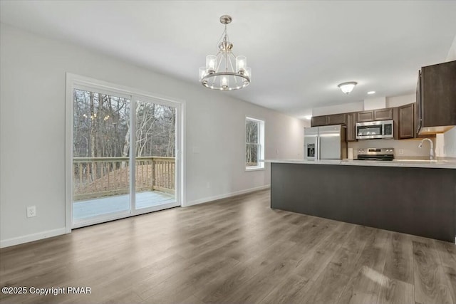 kitchen with stainless steel appliances, a wealth of natural light, and light countertops