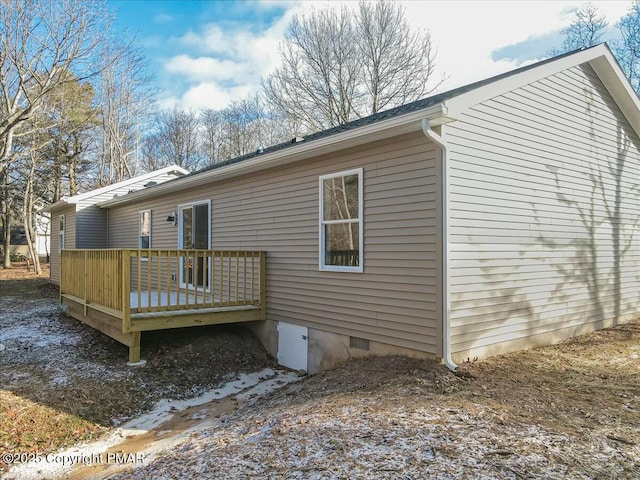 rear view of property with crawl space and a deck