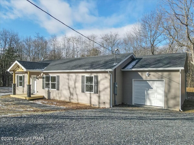 ranch-style house featuring a garage, driveway, and roof with shingles