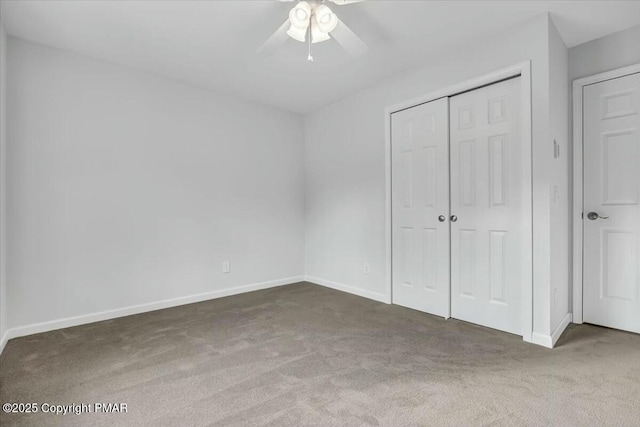 unfurnished bedroom with a ceiling fan, a closet, carpet flooring, and baseboards