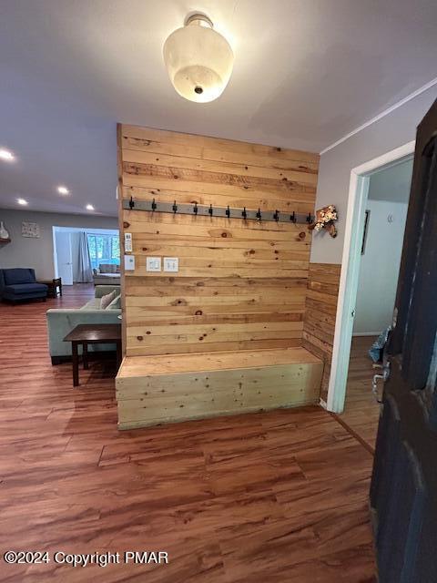 mudroom featuring wood finished floors and wood walls