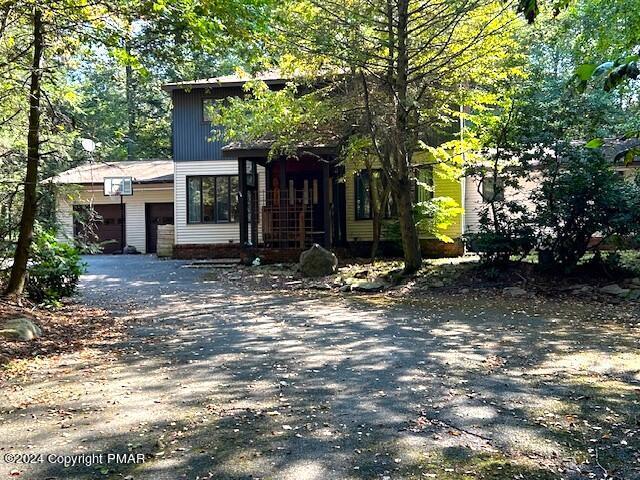 view of front of house featuring aphalt driveway and an attached garage