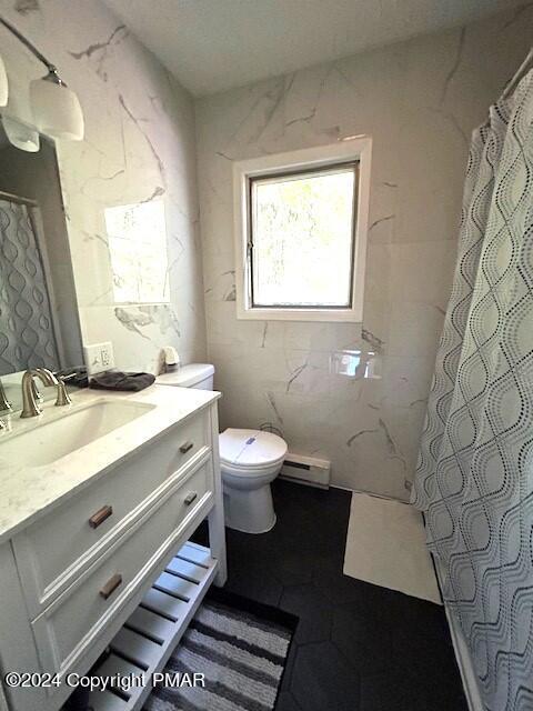 bathroom with toilet, curtained shower, tile walls, baseboard heating, and vanity