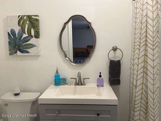 bathroom featuring toilet and vanity