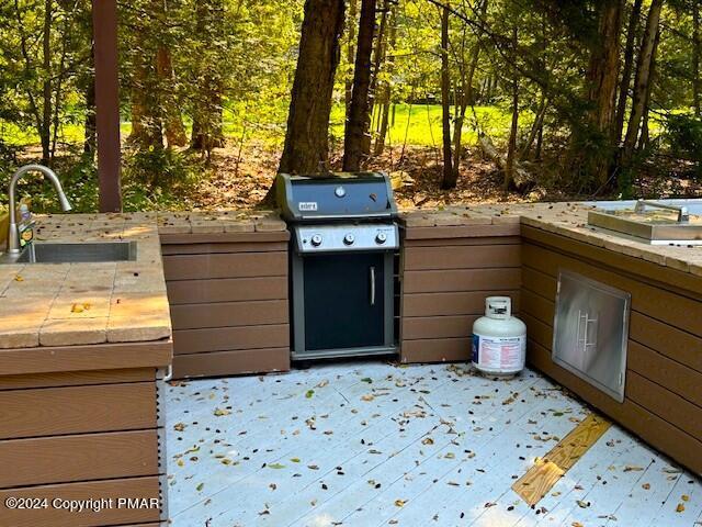 view of patio featuring area for grilling and a sink