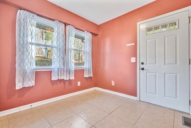 foyer featuring light tile patterned flooring, visible vents, and baseboards