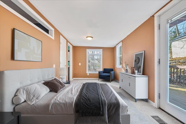 bedroom featuring light carpet, visible vents, baseboards, and access to exterior