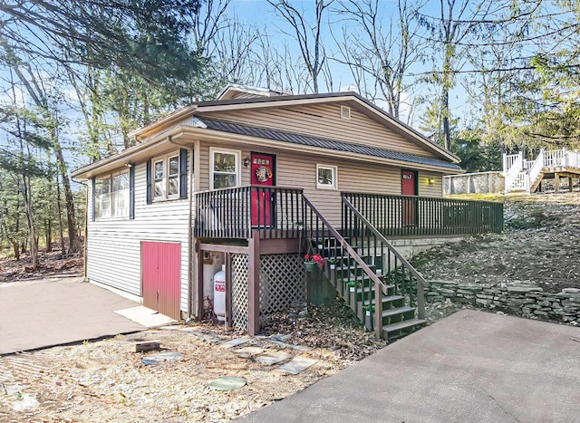 view of front facade featuring stairs and a patio area