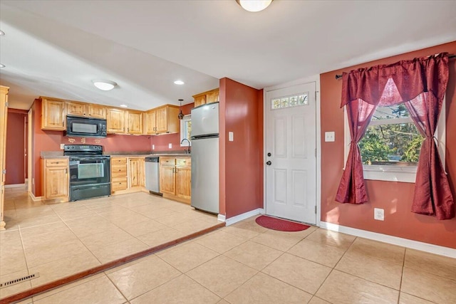 kitchen featuring black appliances, light tile patterned floors, recessed lighting, and baseboards