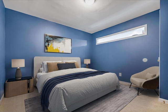 carpeted bedroom featuring baseboards