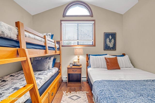 bedroom featuring multiple windows, a baseboard radiator, wood finished floors, and vaulted ceiling