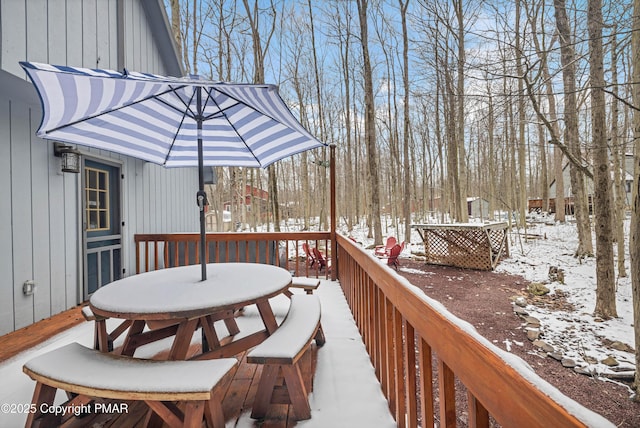 snow covered deck with outdoor dining space