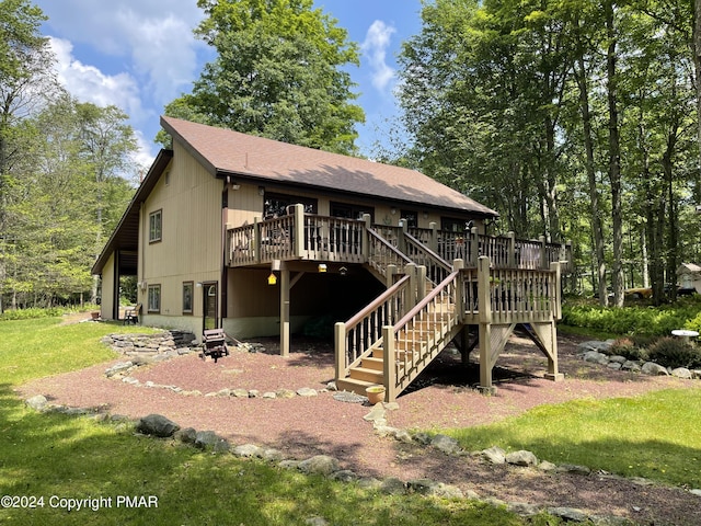 view of front of home with roof with shingles, stairs, a front lawn, and a wooden deck