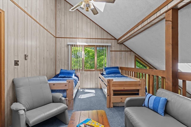 103 Mountainside Dr, Gouldsboro, PA 18424 - carpeted bedroom with lofted ceiling, wood walls, a textured ceiling, and ceiling fan