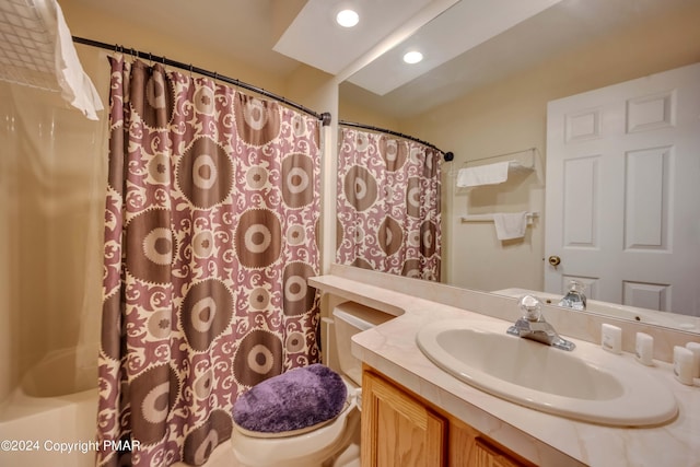 bathroom featuring recessed lighting, toilet, and vanity