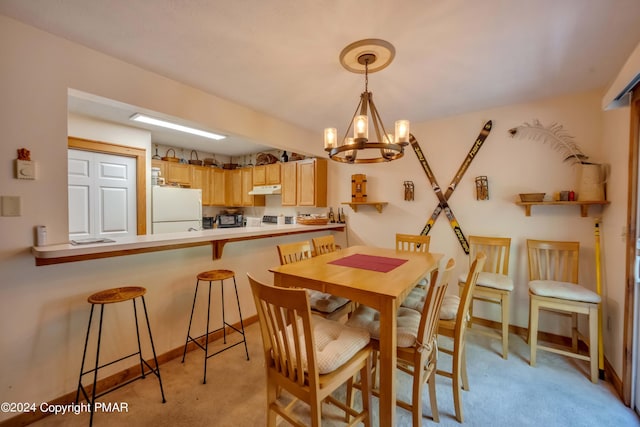 dining space with light colored carpet, baseboards, and an inviting chandelier