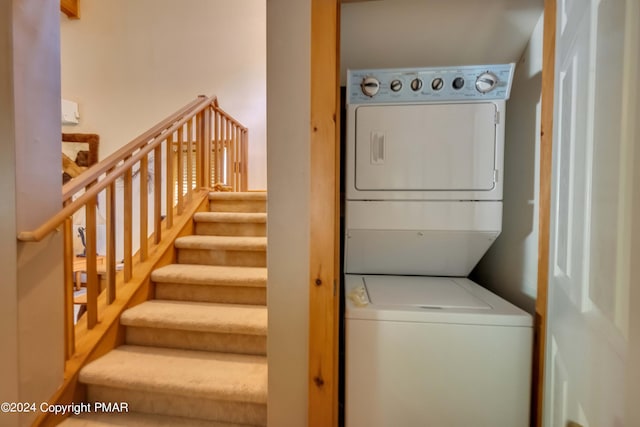 clothes washing area featuring laundry area and stacked washer / drying machine