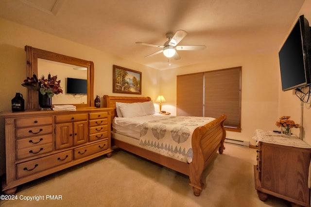 bedroom with light carpet, baseboard heating, and a ceiling fan