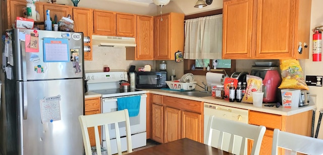 195 Bellingham Dr, Bushkill, PA 18324 - kitchen with white appliances, under cabinet range hood, and light countertops