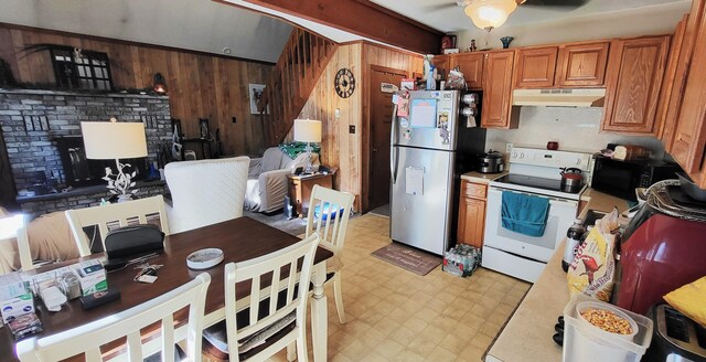 195 Bellingham Dr, Bushkill, PA 18324 - kitchen featuring electric stove, freestanding refrigerator, under cabinet range hood, light flooring, and wood walls