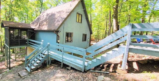 195 Bellingham Dr, Bushkill, PA 18324 - back of house with stairway, roof with shingles, and a sunroom