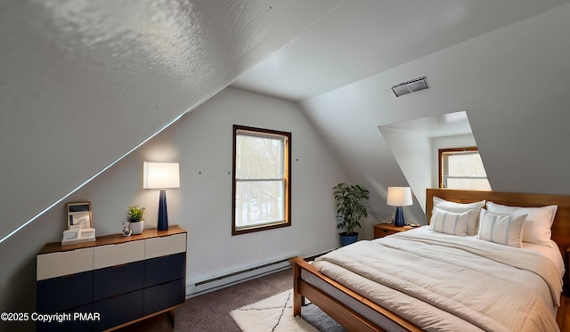9860 Deerwood Dr, Tobyhanna, PA 18466 - carpeted bedroom with a baseboard heating unit and vaulted ceiling