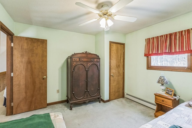 bedroom featuring a ceiling fan, light carpet, and a baseboard radiator