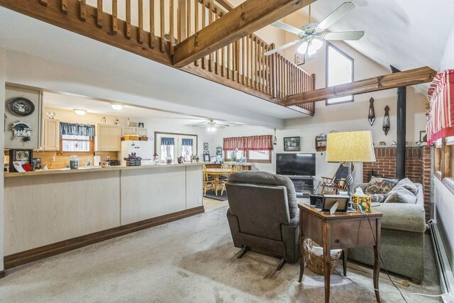 living area with light colored carpet, a ceiling fan, a baseboard heating unit, and high vaulted ceiling