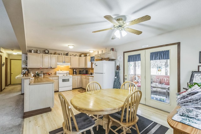 dining room with light wood-style floors and a ceiling fan