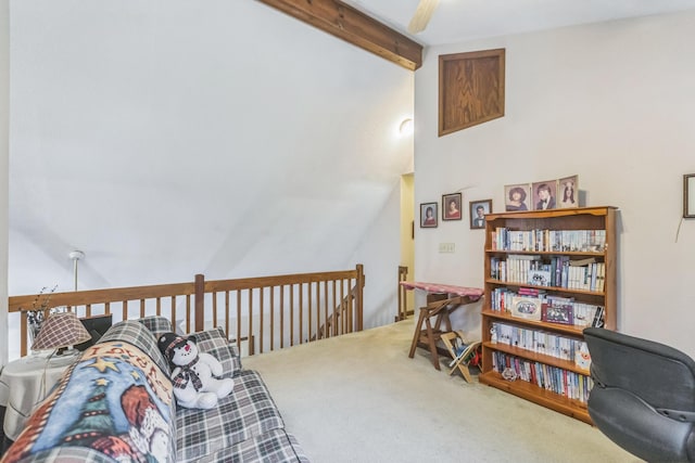 living area with lofted ceiling with beams, carpet, and an upstairs landing