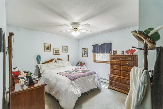 bedroom with a ceiling fan, carpet, and baseboard heating