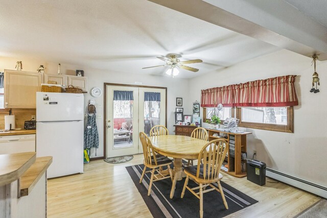 dining space featuring french doors, ceiling fan, baseboard heating, and light wood-style flooring