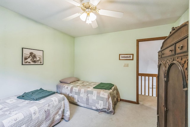 carpeted bedroom with baseboards and a ceiling fan